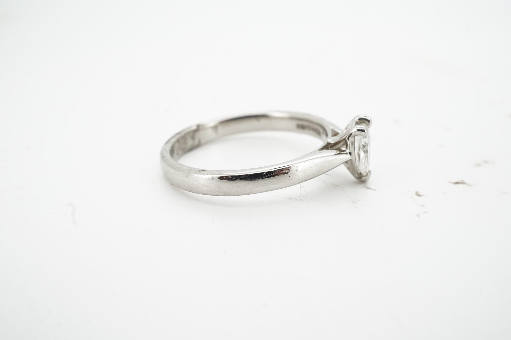 A diamond ring, claw-set with a pear-shaped diamond weighing approximately 0.45 carats, mounted in platinum, size L1/2, British hallmarks, gross weight approximately 4 grams